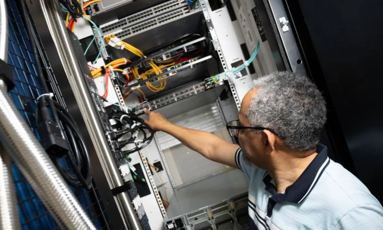 Photo of individual showing an AI Makerspace server. 