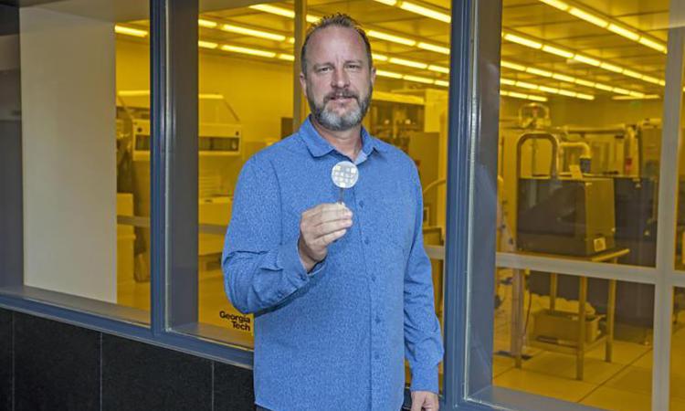Photo of Professor Doolittle holding an Aluminum Nitride-based Semiconducto