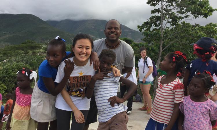 Jiaqing Li and Patrick Pierre hang with the Thoman locals.