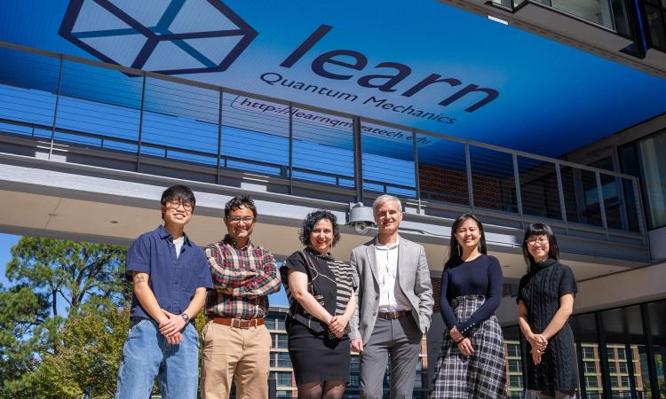 The Learn QM Team in front of a the Media Bridge Display