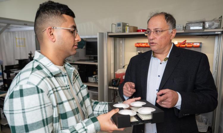  Professor Emmanouil Tentzeris and Ph.D. candidate Marvin Joshi holding an energy harvester.