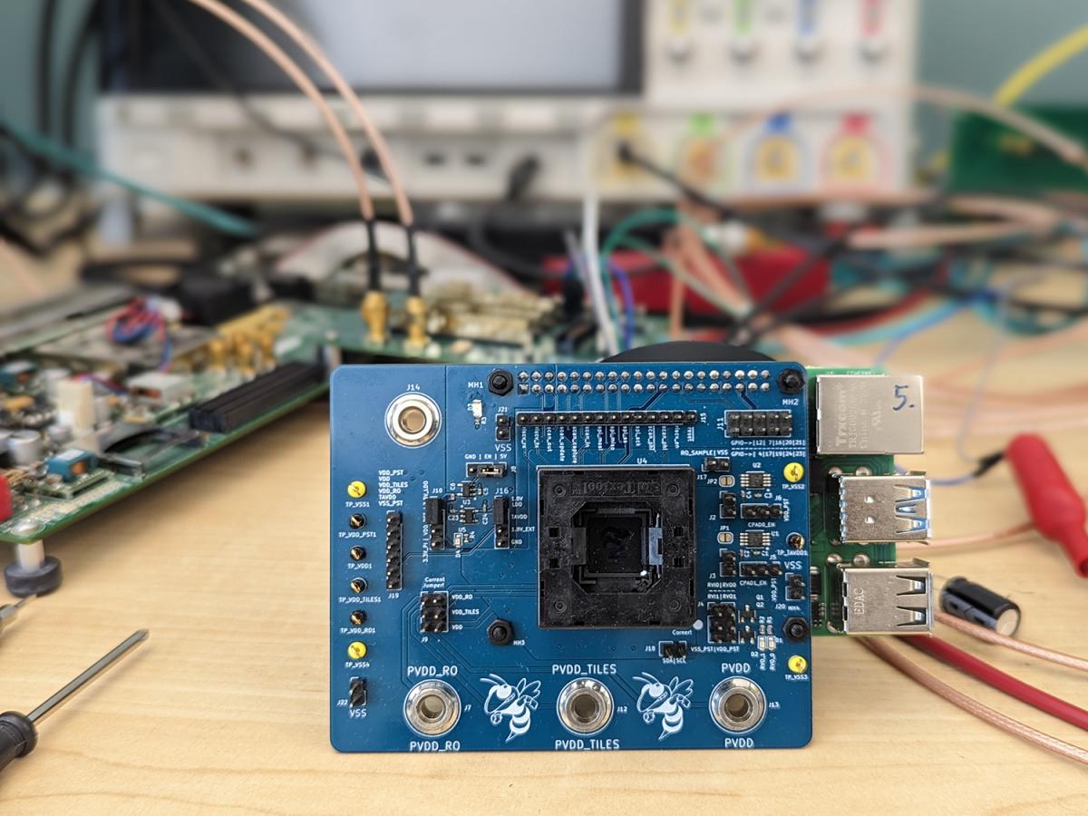 A picture of one of the final printed circuit boards that includes the chip created by the student groups in ECE 4804