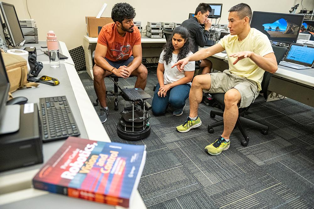 ECE students collaborating on a computer vision and control project.