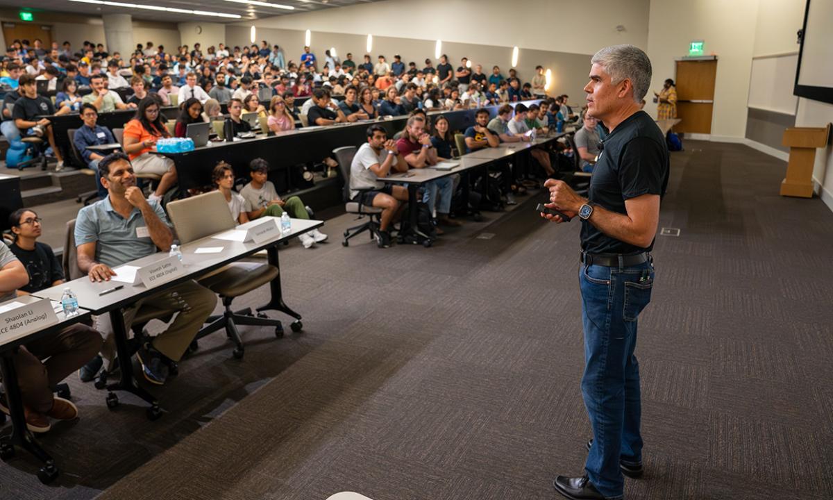 An Apple engineer addressing Georgia Tech electrical and computer engineering students on how the company's New Silicon Initiative will provide students with enhanced support, mentorship, and opportunities for those interested in hardware engineering careers.