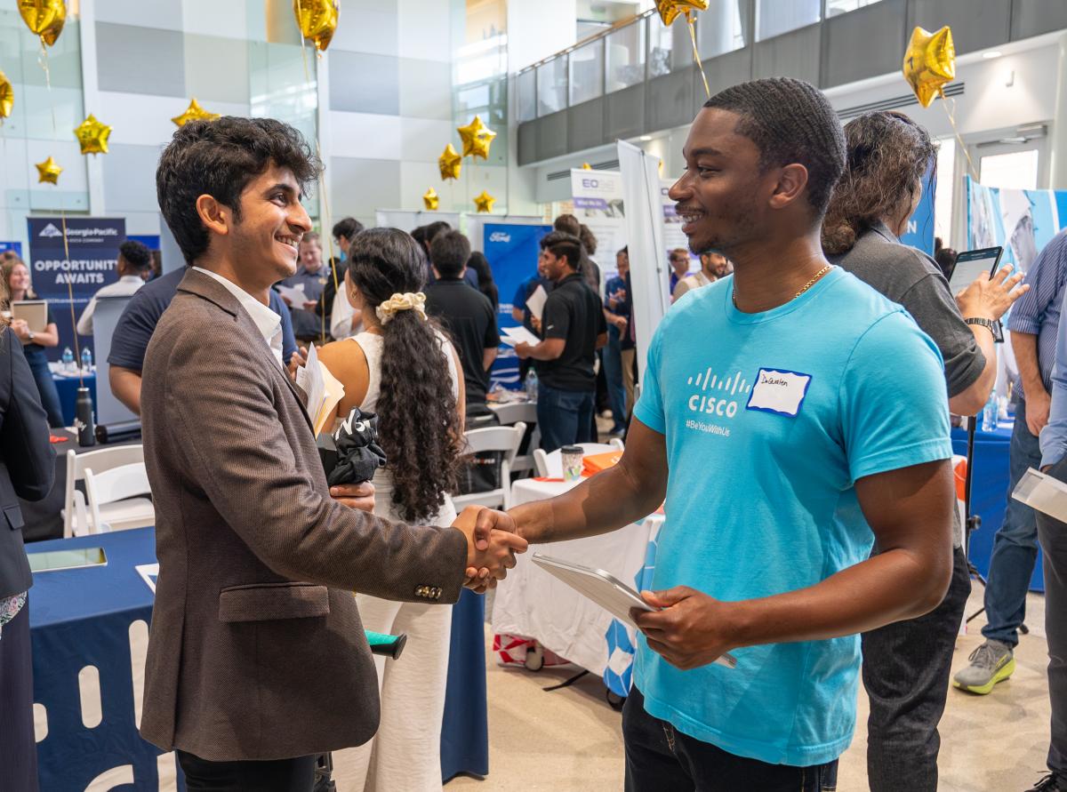 Students in conversation with recruiter at Career Fair 