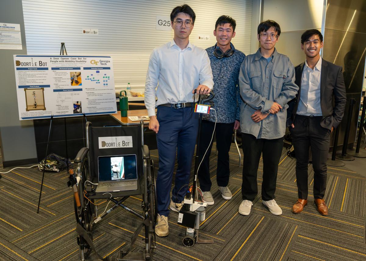 Photo of team DoortleBot showing off their device.