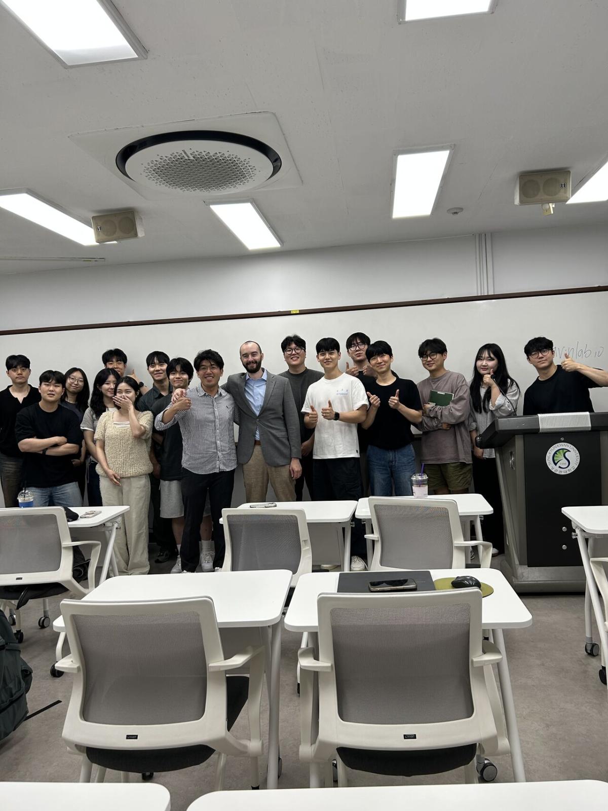 Professor Matthew Flavin posing with students