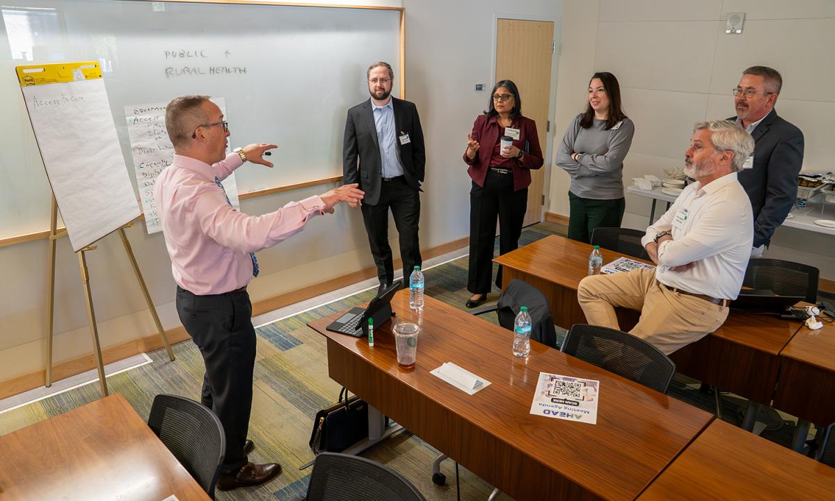Researchers and healthcare industry representatives meeting at Georgia Tech to discuss the Accessible Healthcare through AI-Augmented Decisions (AHeAD) Center.