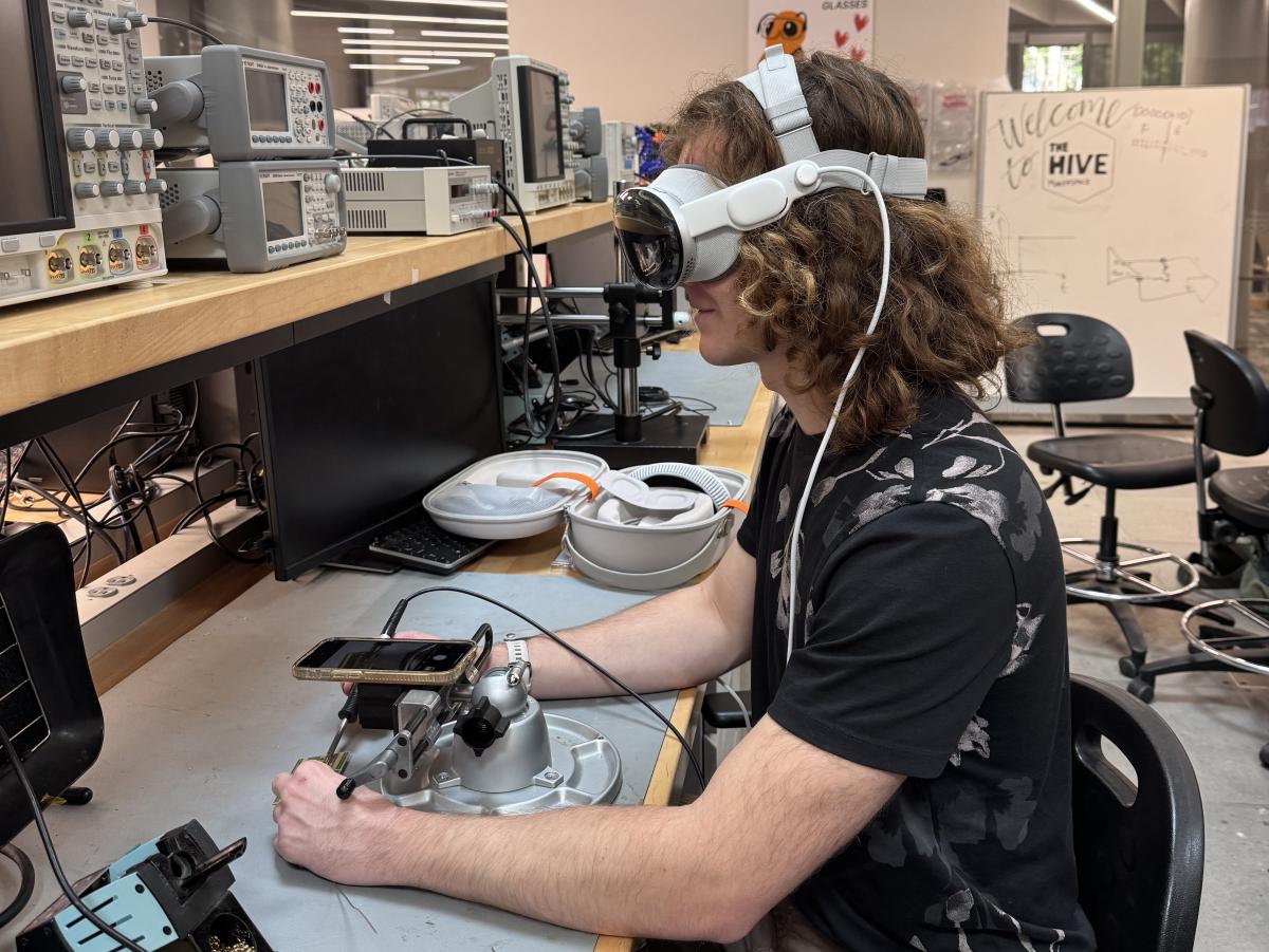 Student Matthew Bowlby demonstrating another project in the Technology Entrepreneurship course that uses Apple Vision Pro to digitally enhance the circuit board soldering process. 