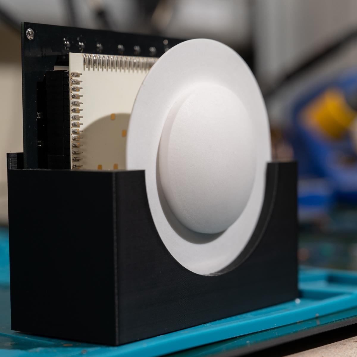 A close look at the harvester’s lens and antenna array, which gather 5G signals from all directions and focus them into usable power.