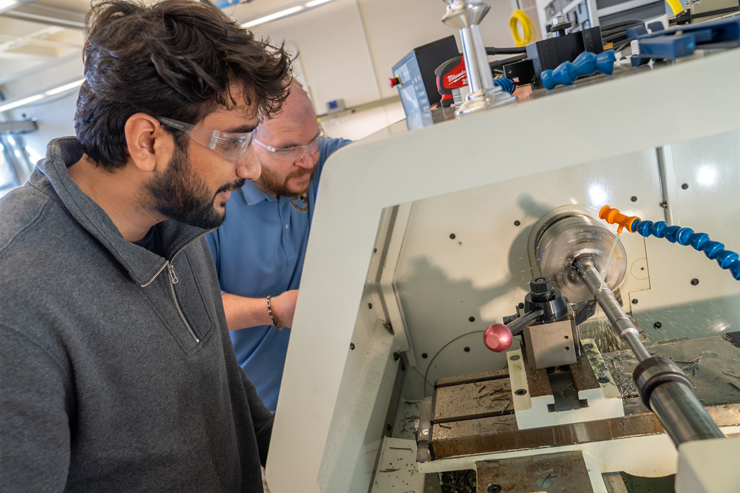 Piyush Chauhan operating a CNC machine