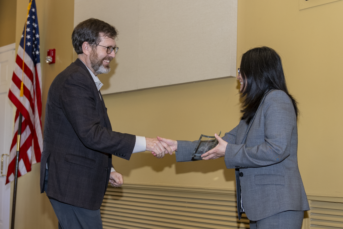 Professor Jeffery Davis receiving the Outstanding Faculty Award for Excellence in Teaching from Senior Associate Chair Ying Zhang at the 2026 Roger P. Webb Awards.