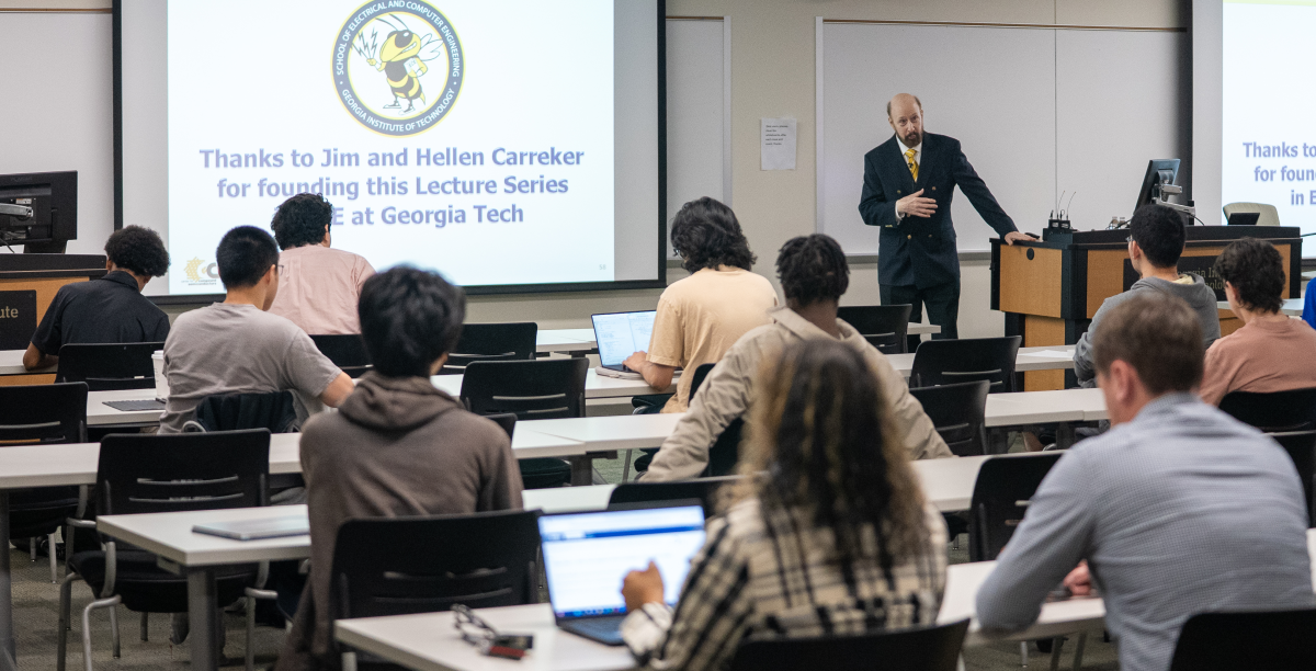 Professor Russell Dupuis stands at the front of a lecture hall speaking to an audience seated at desks during the Carreker Distinguished Lecture at Georgia Tech.