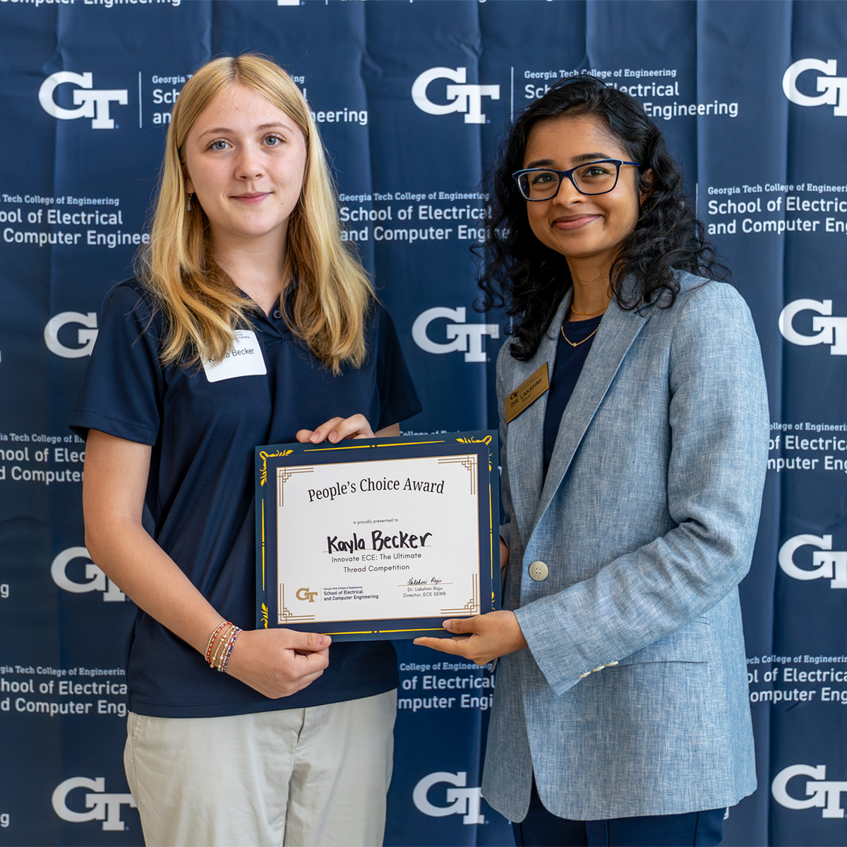 Becker holds her People’s Choice Award with Lakshmi Raju at the Innovate ECE Demo Day. 