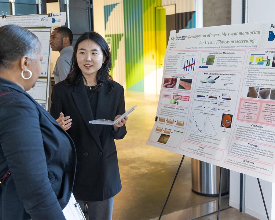 A VIP student discusses research during a poster competition highlighting the hands-on, multidisciplinary projects that are a hallmark of the program.