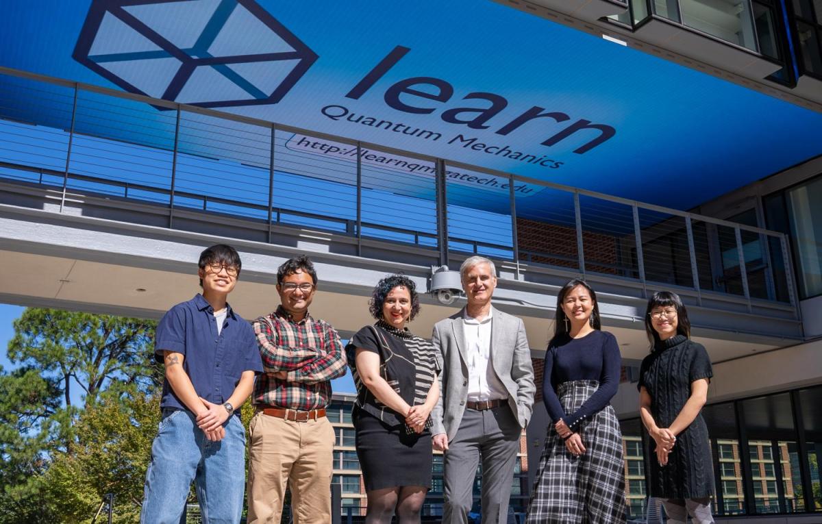 The Learn QM Team in front of a the Media Bridge Display