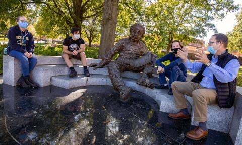 ECE Professor Bernard Kippelen (far right) with his students at the Einstein statue. 