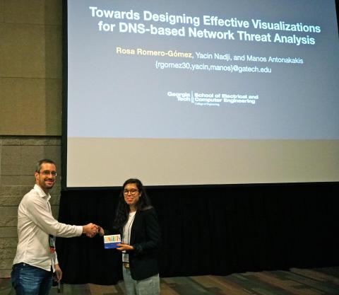 ECE Postdoctoral Researcher Rosa Romero-Gomez accepts the Best Paper Award at VizSec 2017.