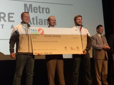 Chris Hart, owner of Southern Refreshment Services, presents award check to Gimme co-founders Cory Hewett (L) and Evan Jarecki (R).